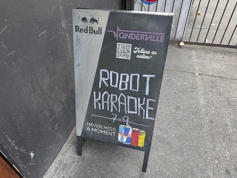 photo of the sandwich board outside wonderville announcing robot karaoke was happening that evening