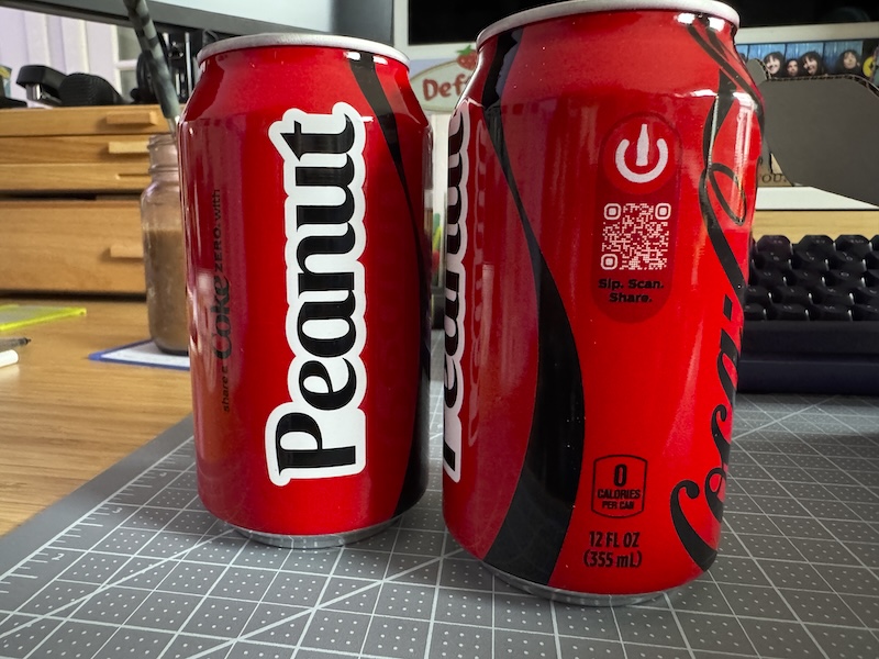 photo of two coke zero cans on my desk that were customized to say "Peanut" on them