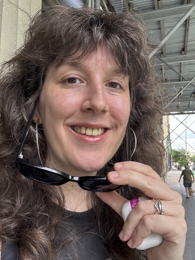 an impromptu selfie where i'm smiling but very much dead behind the eyes