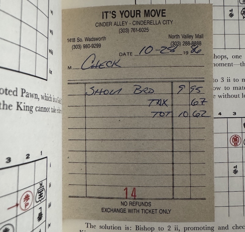 an old receipt from from 1986 from the denver store "its your move" inside of a shogi book associated with the receipt
