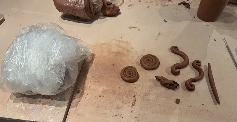 photo of some handles and feet i was practicing with red clay at the ceramics studio
