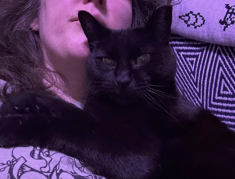selfie of me on the couch with my black cat pumagreg laying on me