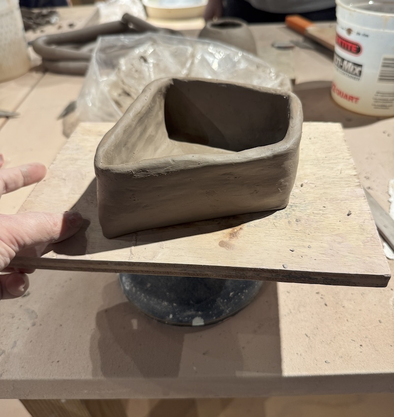 photo of a trapazoidal coil pot i made, still a bit wet on the board here