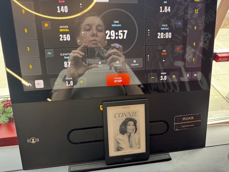 treadmill screen reflection selfie on monday after i walked a half hour, my ebook reader shows connie chung since i was reading her memoir