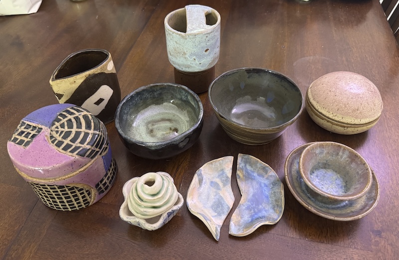 a photo of 9 varied ceramic pieces i made, all together on my table for display. the pieces are described in detail in this post