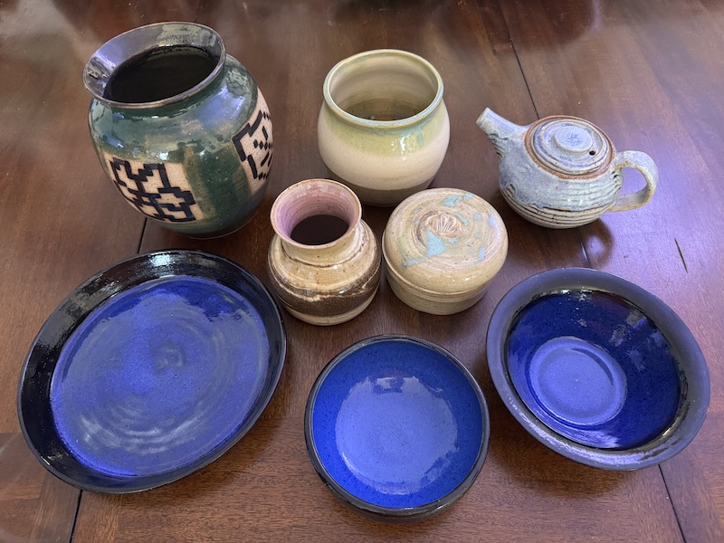 a photo of all of my pottery together on my table: a blate, two bowls, three vases, a closed vessel and a teapot