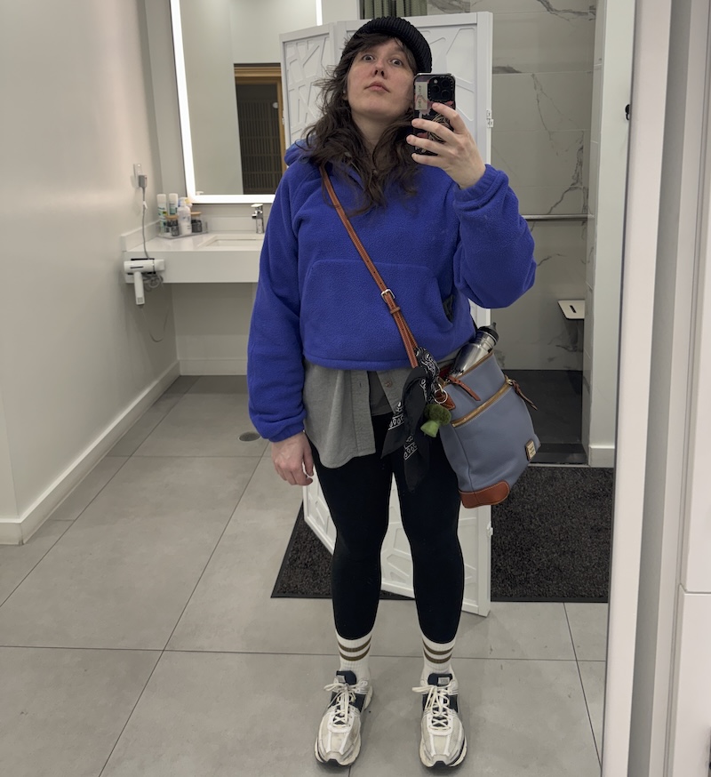 photo of me bundled up in my gym clothes and fleece as i leave the gym for the cold outdoors and i'm not looking forward to it from the looks of my face