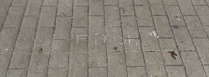 photo of the ground and a kid wrote "finish" in chalk