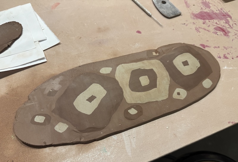 photo of my clay slab with different colors layers of squares in different colored clay bodies rolled onto it