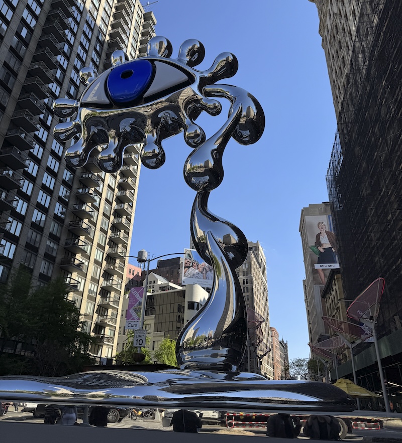 photo of a 30 foot tall mirrored steel "evil eye" sculpture by charlotte colbert