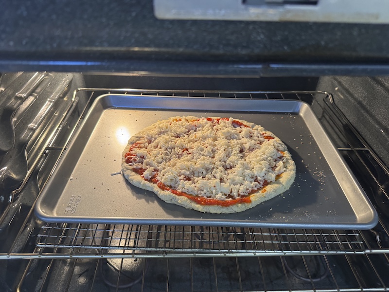photo of a cheese pizza i just put into the oven to bake