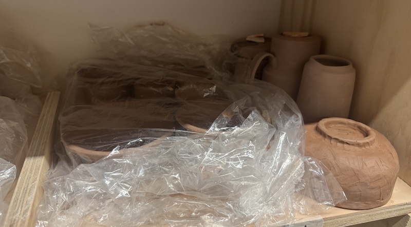 photo of a bunch of greenware pottery on a shelf