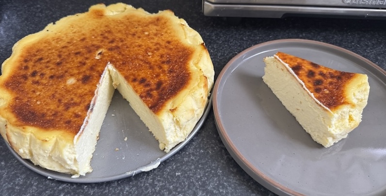 photo of a basque cheesecake i made with a slice cut out