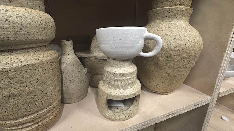a photo of a bunch of ruined bisqueware and one piece is my wax melter with someones tea cup stuck to it