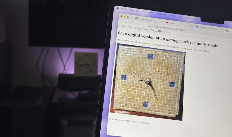 a photo my laptop showing my digital version of my analog clay clock, and in the background is that clay clock showing the same time