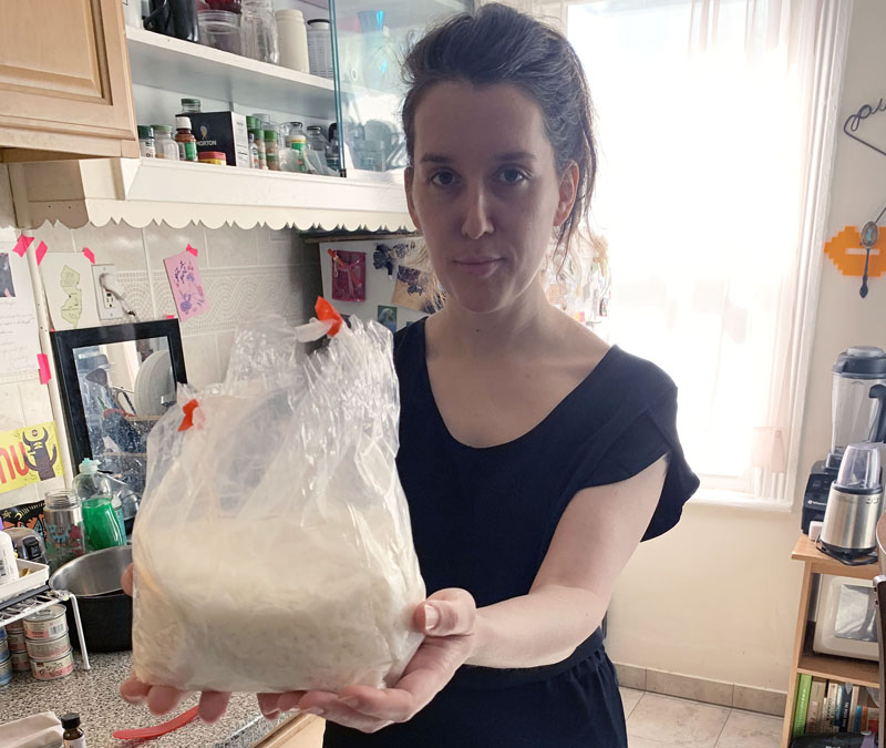 me holding up a big bag of wax
