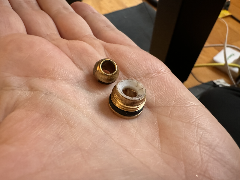 photo of my hand holding the small ball and washer from inside the drain valve