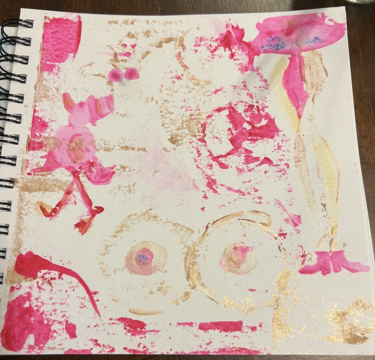 an abstract watercolor painting in my sketchbook of pink and gold paint, it's got a couple of boobs, a duck, and paint splatter