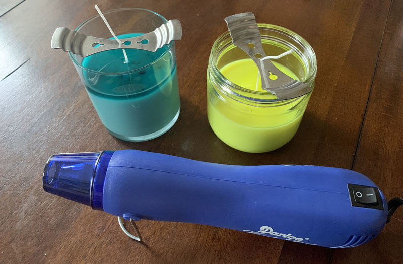 the two candles with a layer of hot wax and below them is my heat gun