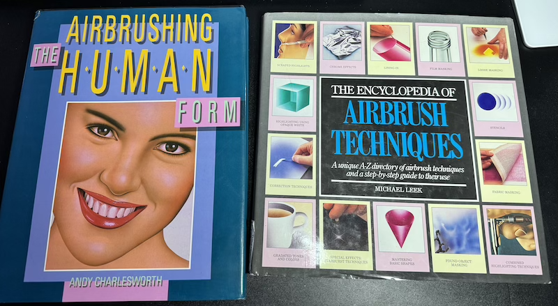 photo of two different books, "the airbrushing human form" by andy charlesworth and "the encyclopedia of airbrush techniques" by michael leek