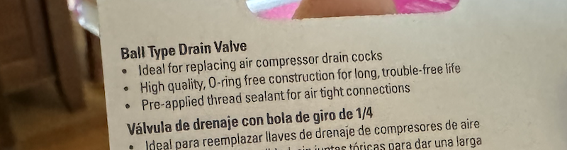 photo of the back of the packaging saying "ball type drain valve: ideal for replacing air compressor drain cocks, high quality o-ring free construction for long, trouble-free life, pre-applied thread sealant for air tight connections"