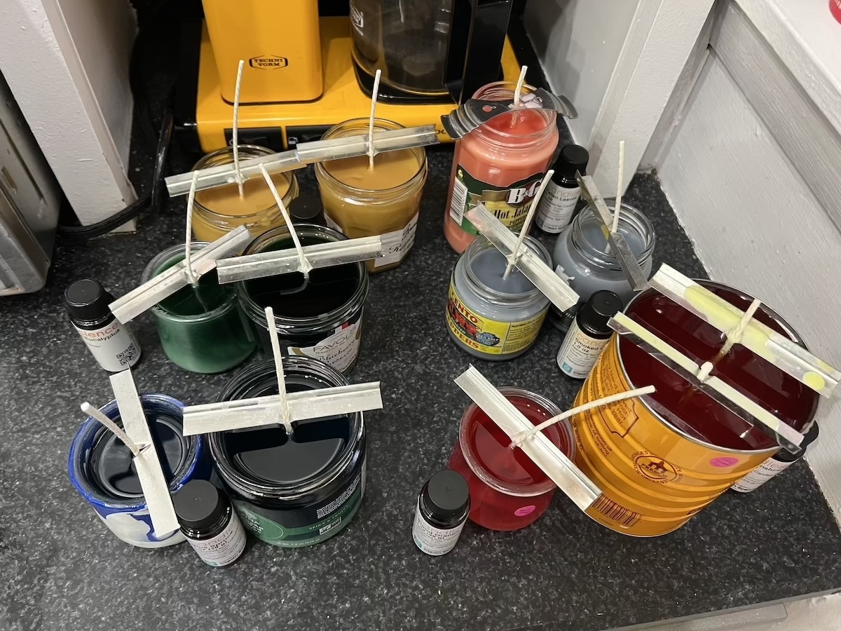 photo of a bunch of melted candles (listed above) on my kitchen counter, just beginning to cure