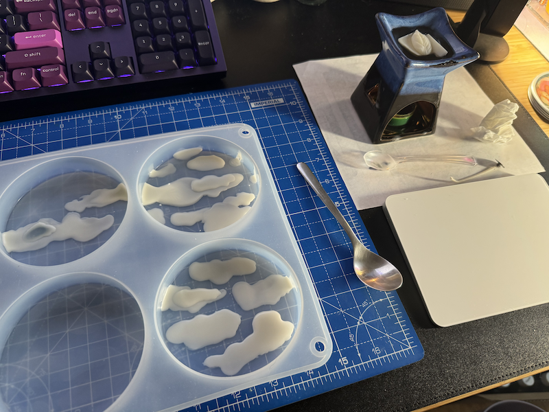 photo of my desk where i'm "painting" wax clouds for an upcoming set of candles i'm making