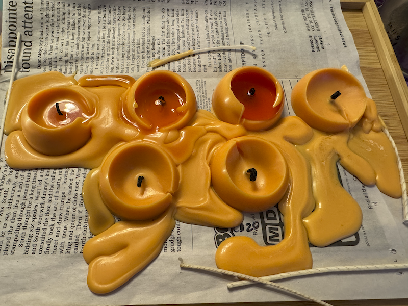 6 egg yolk candles i made that are melted after i tested different wicks in them