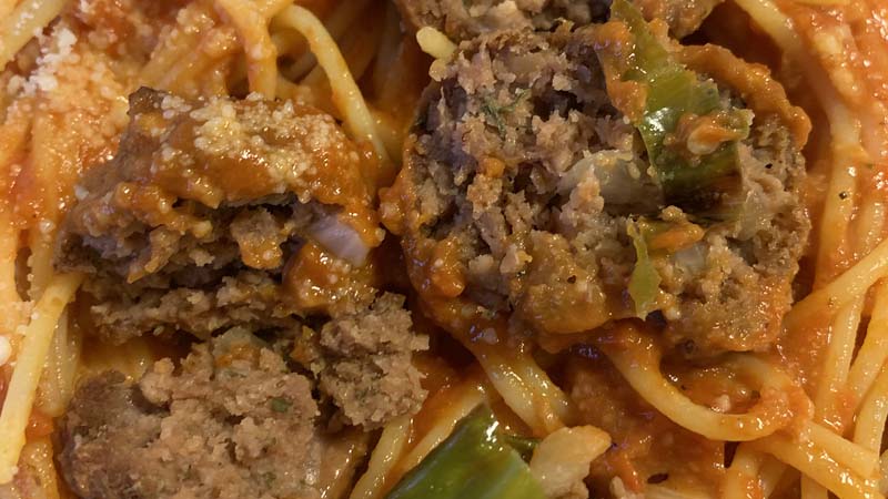 a meatball cut in half to show texture