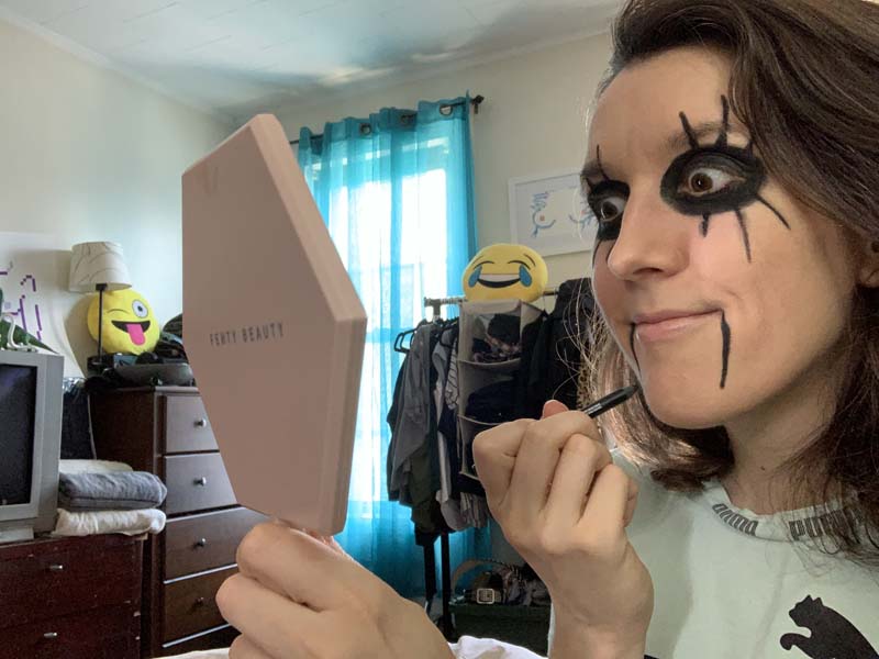 me looking into a mirror menacingly with lines of black coming down from the side of my mouth