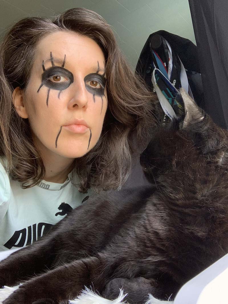 me behind pumagreg, a black cat, and he's looking back at me