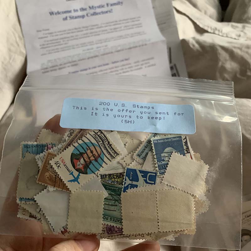 me holding a little ziploc bag full of stamps