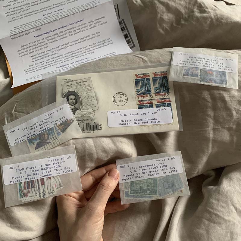 a few bags of stamps on a cream-colored blanket