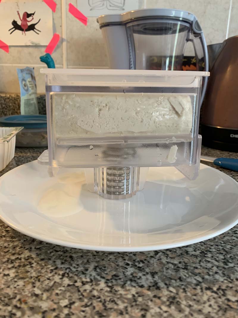 photo of the tofuxpress incorrectly standing upside down on a plate on my kitchen counter