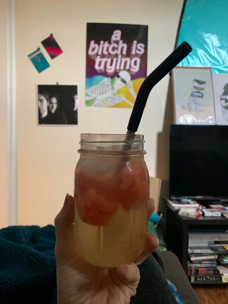 photo of my hand holding up a mason jar with a watermelong mocktail in it