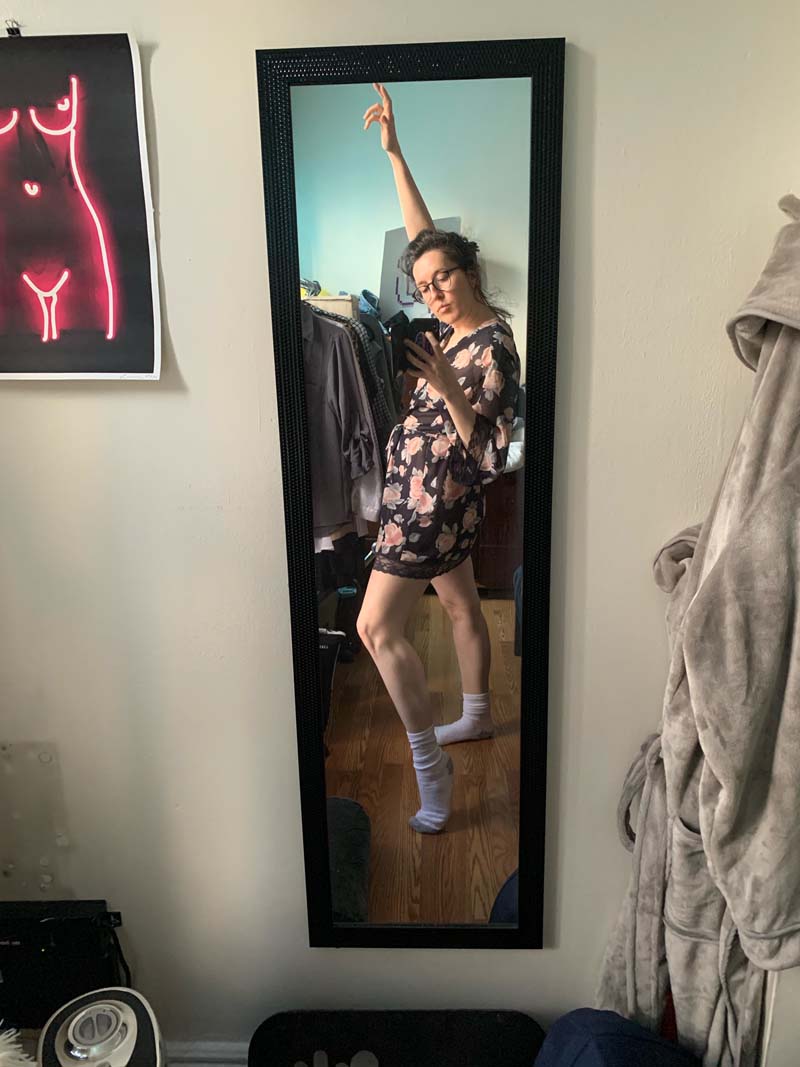 mirror selfie of me dramatically posing while wearing a fancy short robe and tube socks