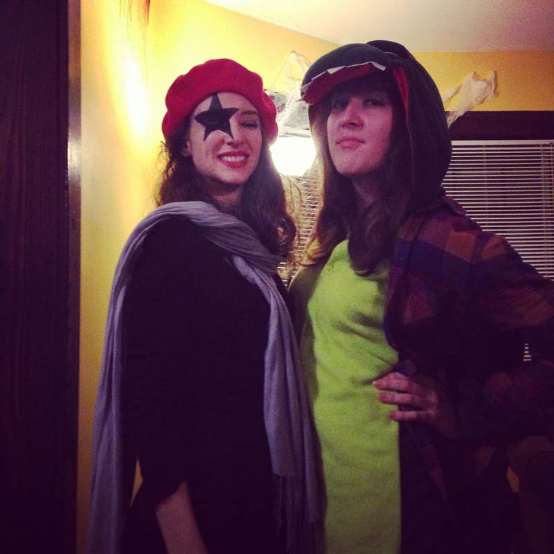 photo me dressed in a dinosaur onesie next to my pal lisa who has kiss makeup on and a mime outfit