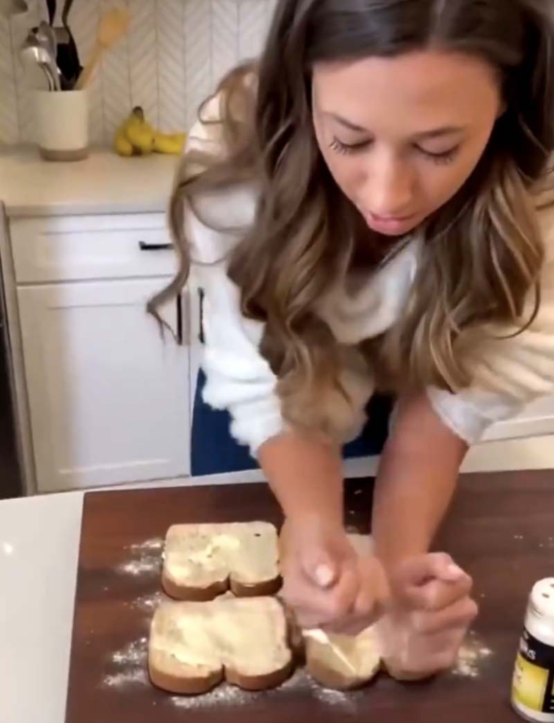 woman pressing bread with her forearms