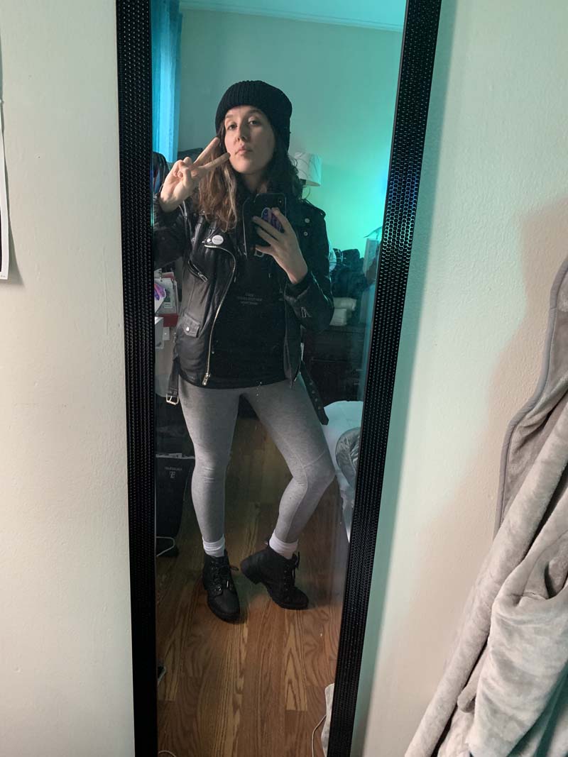 a selfie of me in front of a long mirror in my bedroom. i am wearing gray leggings and a leather jacket and wool hat, since i