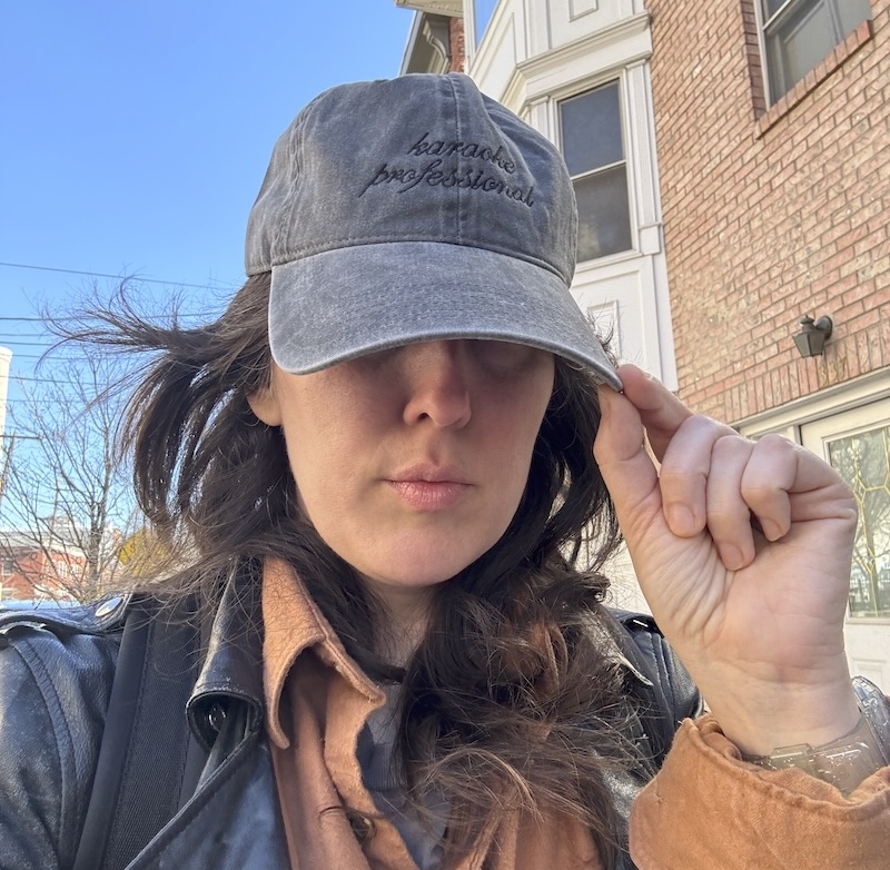 photo of me wearing my "karaoke professional" baseball cap