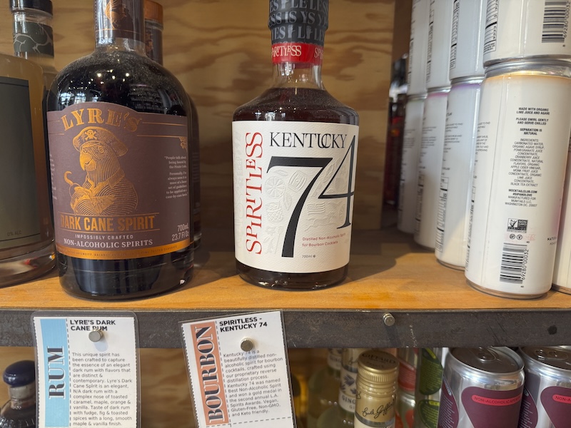a photo of a bottle of non-alcoholic bourbon on the shelf of cool vines in jersey city. the brand is kentucky 74