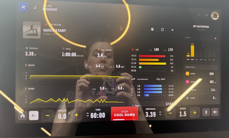 photo of my gym's treadmill and you see me in the reflection. it was an hour long walking incline interval workout