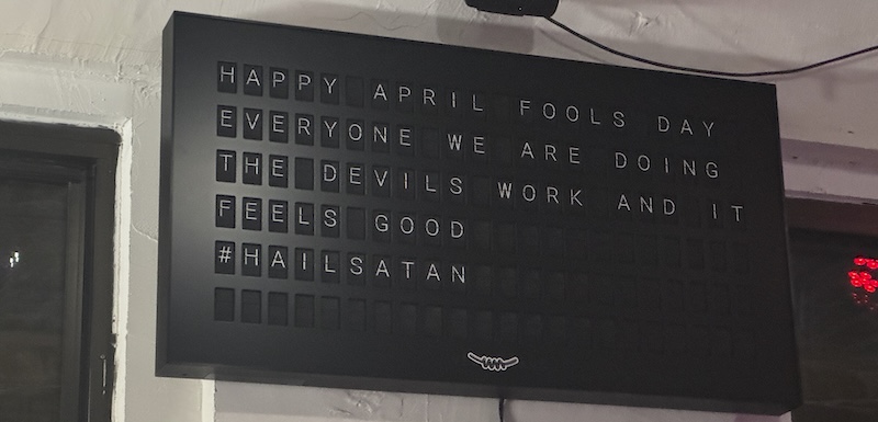 photo of a ticker sign at smooth technology's office that says "happy april fools day everyone we are doing the devils work and it feels good #hailsatan"