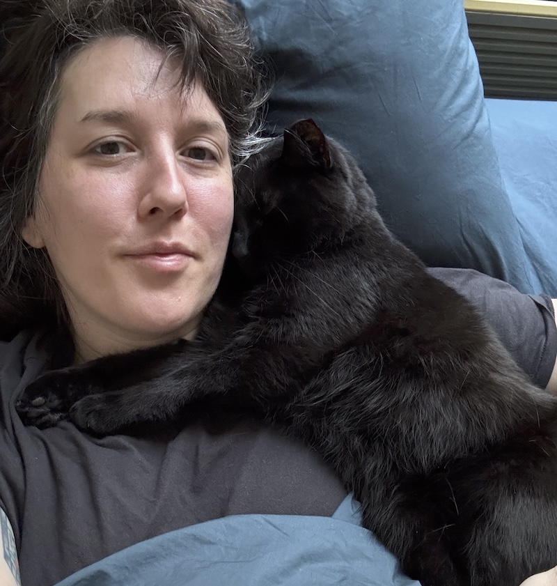 photo of pumagreg smooshing his face into mine while cuddling in bed one morning