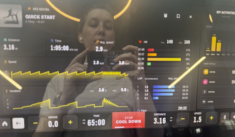 selfie of my reflection in the treadmill during a tuesday walking workout