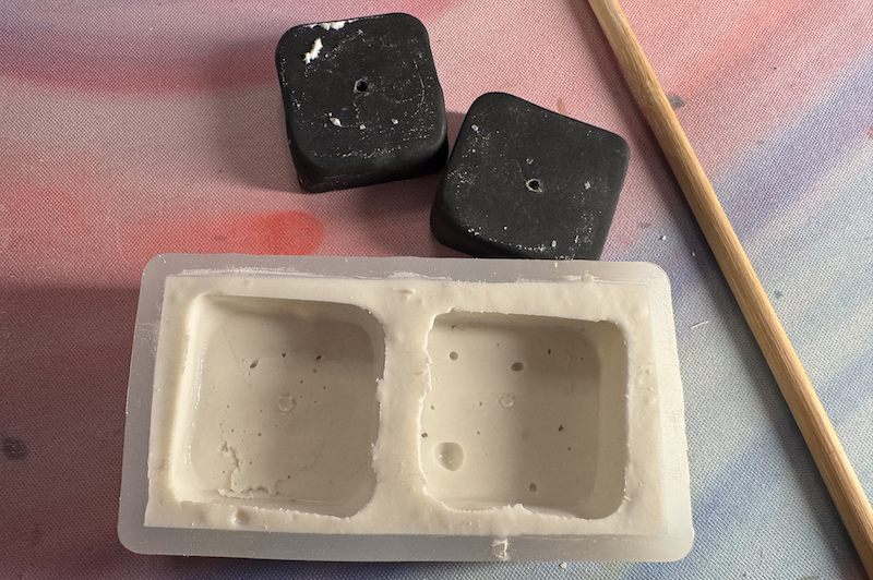 photo of the finished mold, there are some nooks and crannies inside, and the polymer butter tabs outside of the mold