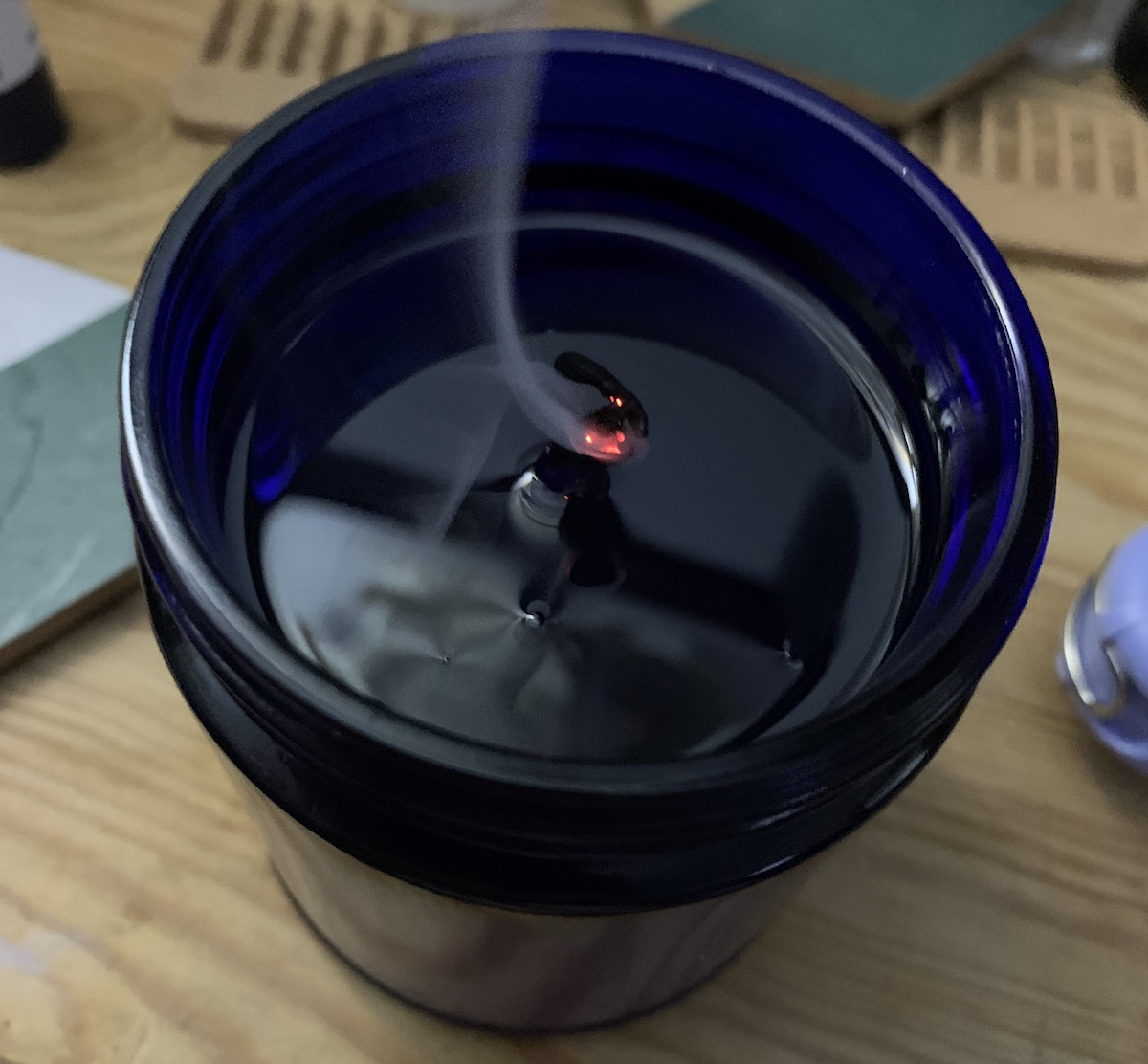 the blue candle with melted wax spanning the entire jar, no tunnel
