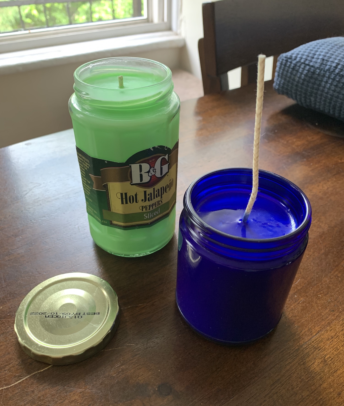 two candles, one green and the other blue, on the table