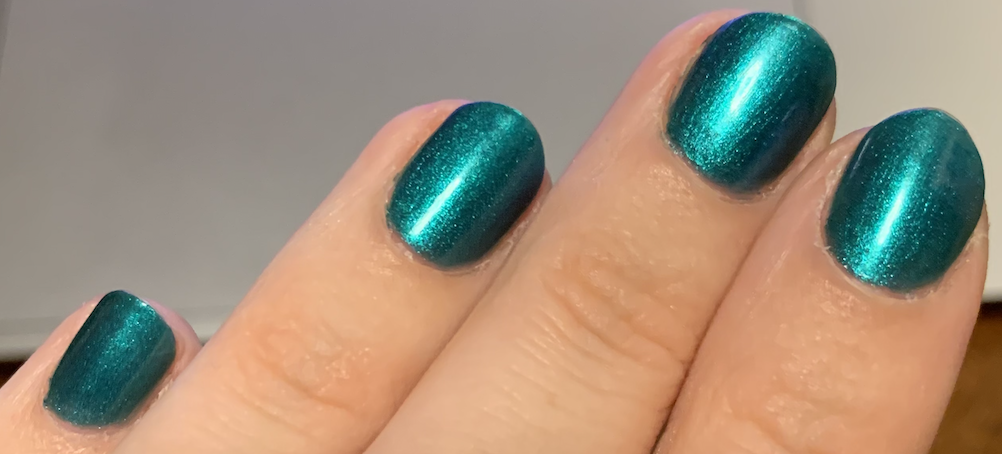 photo of my nails that are emerald metallic green, and the manicure looks fresh and new