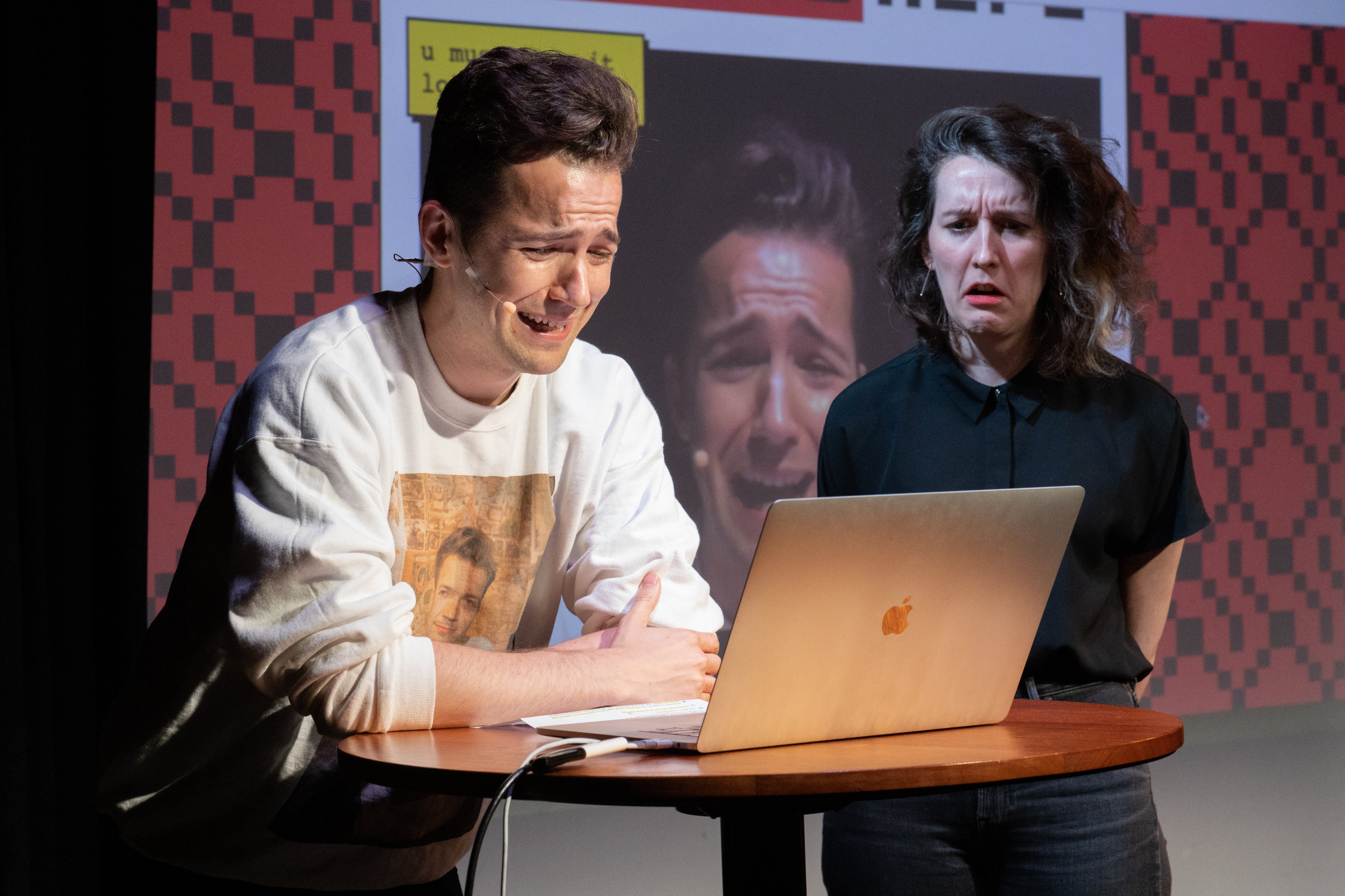 photo of mark and i on stage in front of my computer playing apologyhero and making very expressive sad faces